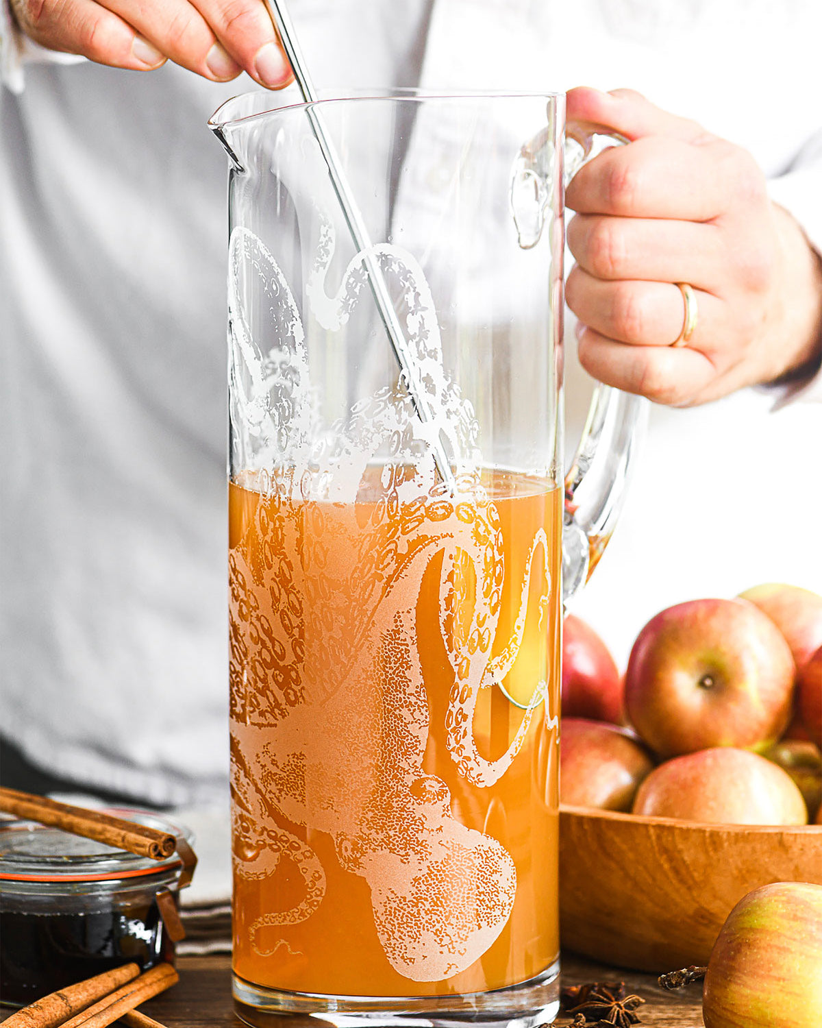 Caskata's Lucy the Octopus Crystal etched Pitcher being stirred with a batch cider cocktail