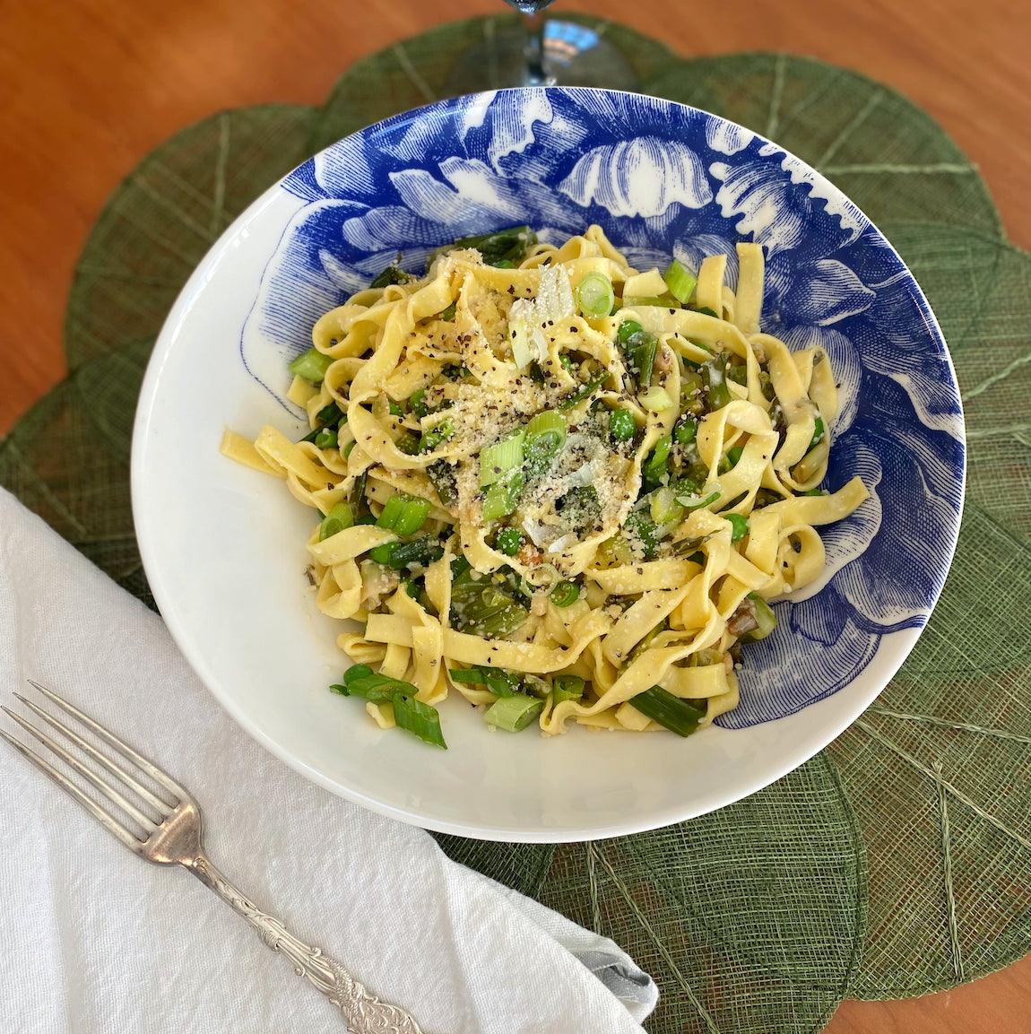 A Peony Soup Bowl holds fresh tagliatelle pasta with peas and scallions..