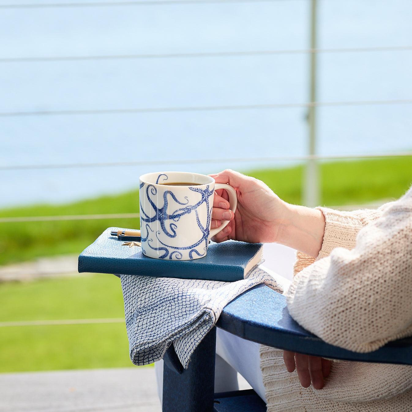 High-fired porcelain Starfish Mug by Caskata Artisanal Home with a blue octopus design; it's dishwasher safe and perfect for ocean lovers.