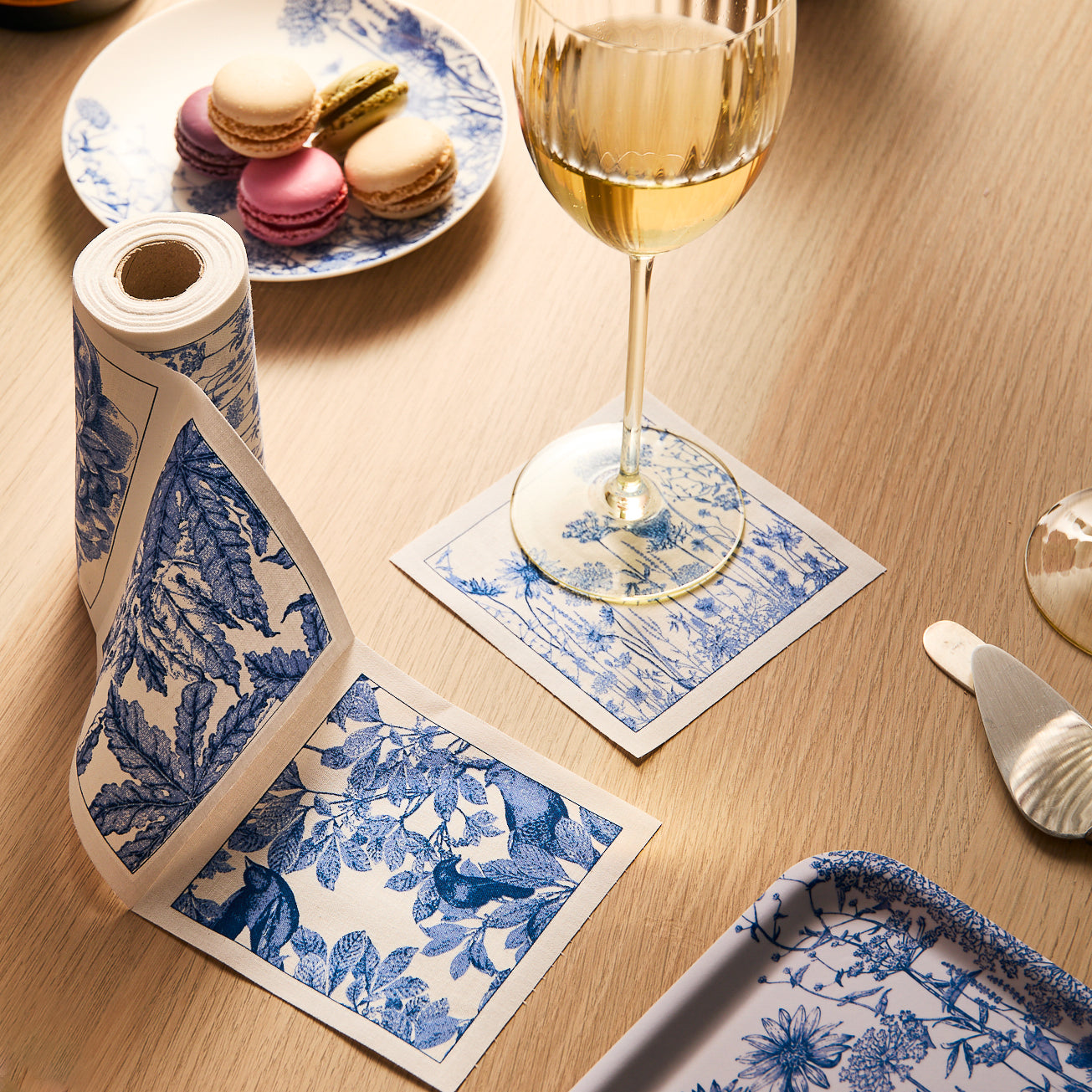 The Quinn Citrine Wine Lovers Set by Caskata features a clear glass carafe with a swirl pattern alongside ten matching Czech crystal wine glasses, each adorned with subtle vertical lines for an elegant handmade touch.