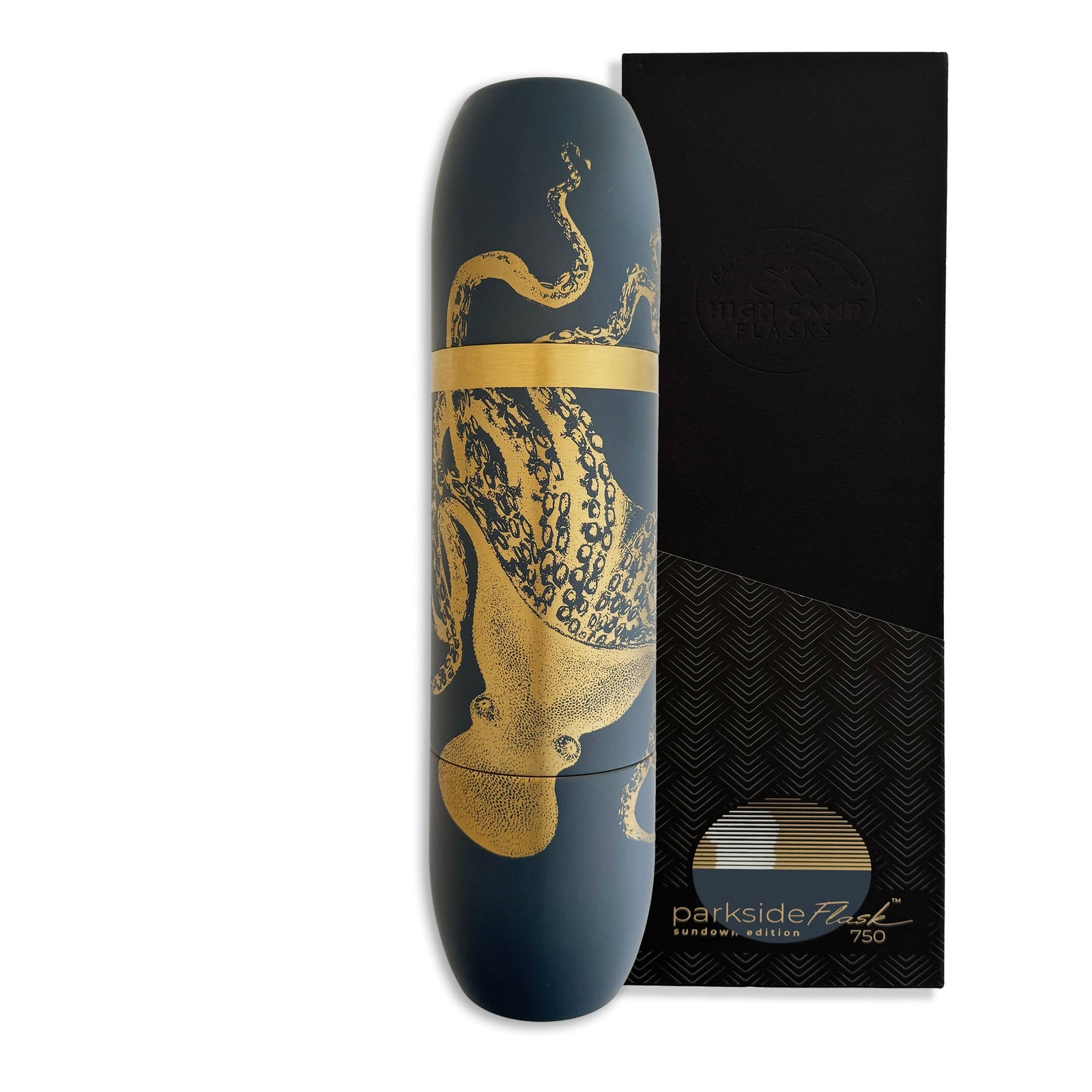 A dark blue Caskata x High Camp Lucy Wine Flask with a gold octopus design rests beside a sleek black box, reflecting the stylish elegance of Caskata’s signature look.