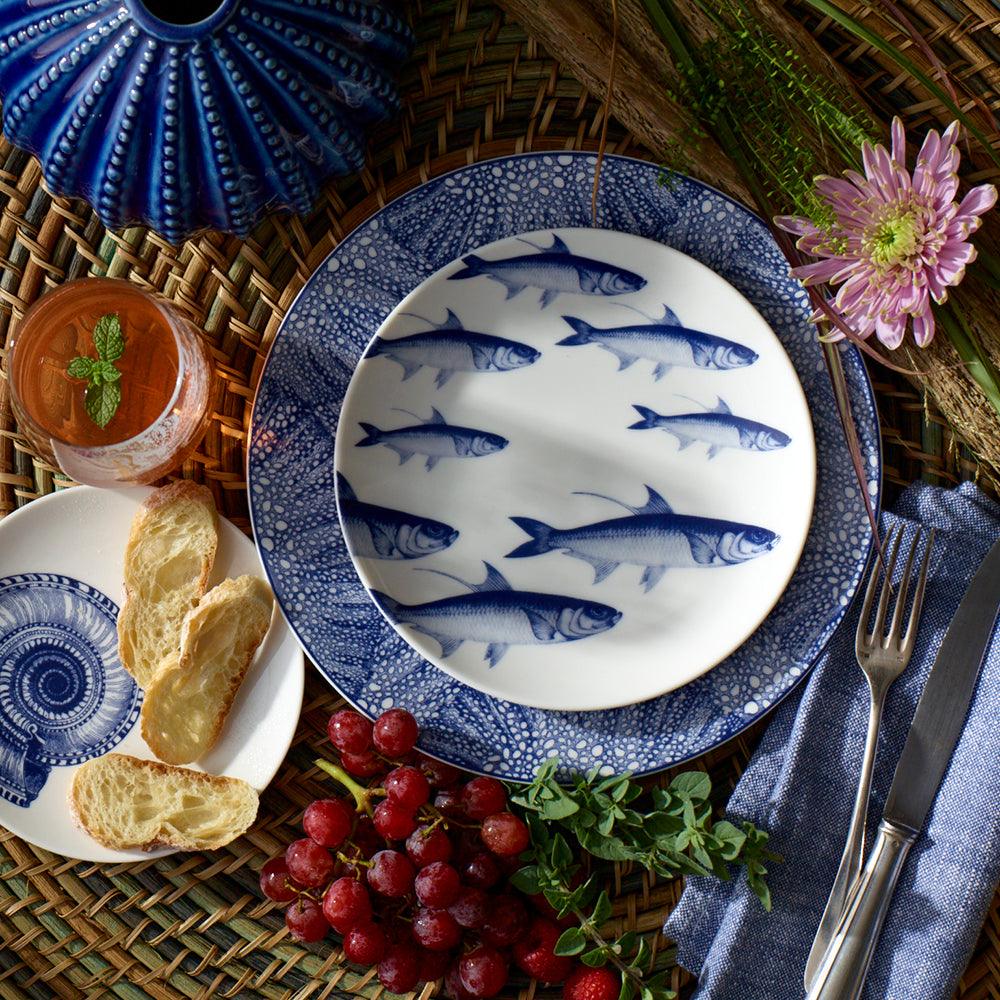 Caskata School of Fish Coupe Salad Plate decorated with a pattern of blue fish.