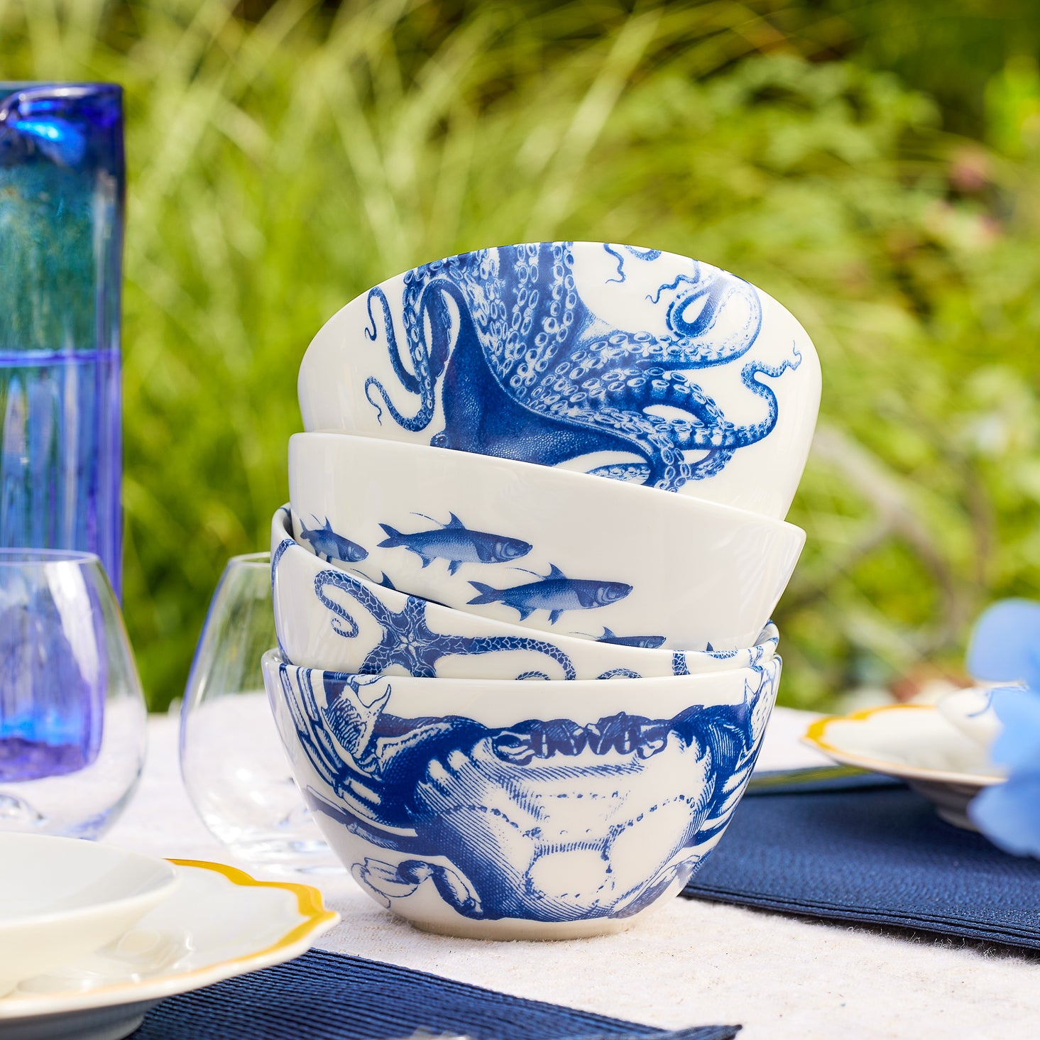 Mixed set of 4 Porcelain cereal bowls in iconic coastal patterns from Caskata including Lucy the octopus, school of fish, starfish, and crab motifs.