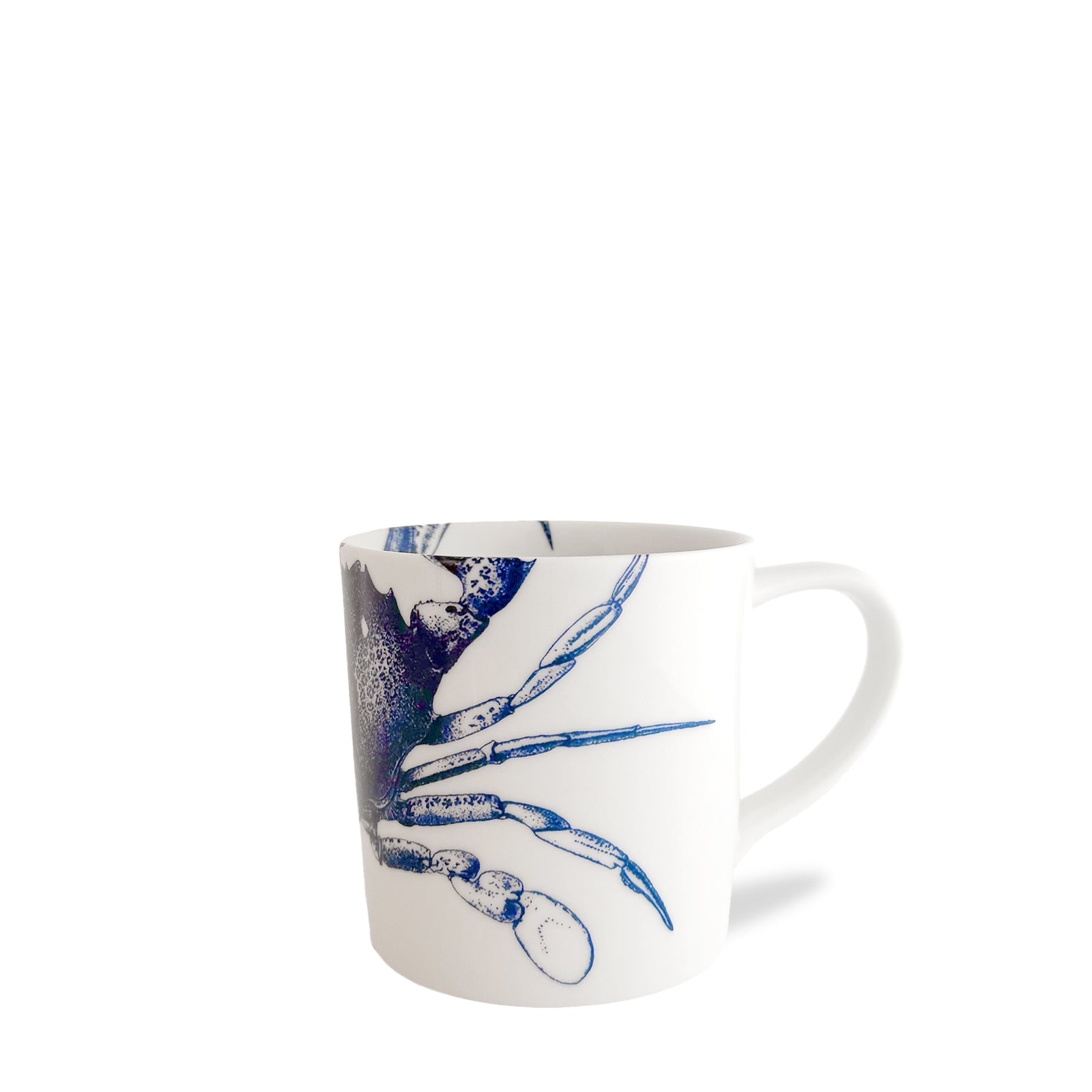 The Caskata Crab Mug featuring a blue crab illustration, made from high-fired porcelain and placed against a plain white background. This dishwasher safe mug from Caskata Artisanal Home is perfect for adding a touch of coastal charm to any kitchen.