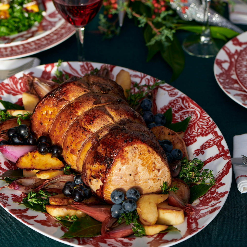 Arcadia Crimson Large Rimmed Platter by Caskata showcases the main course on a festive holiday table.