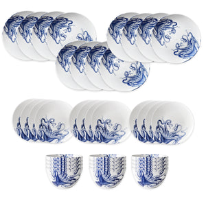 The Lucy Table for 12 by Caskata features blue octopus designs on porcelain plates and cups, arranged neatly in rows on a white background.