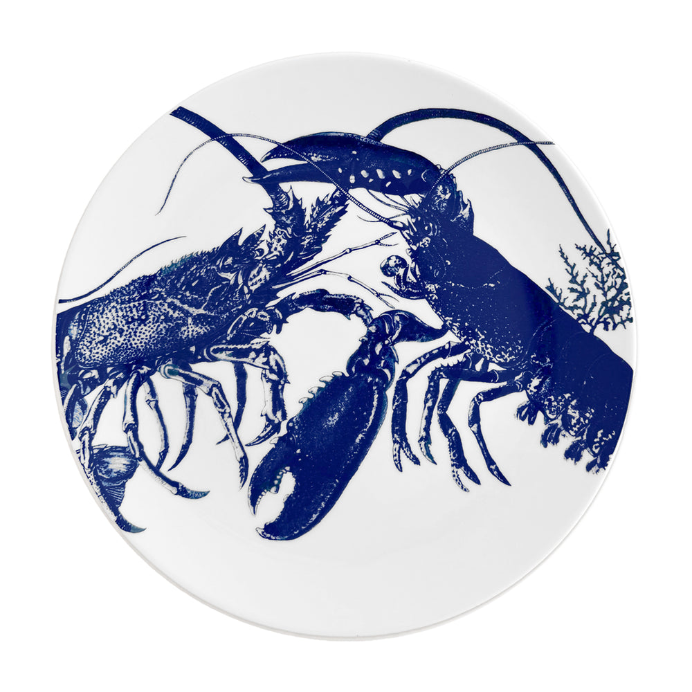 Caskata lobster dinner plate in blue on creamy white porcelain. Dishwasher safe.