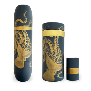 The Caskata X High Camp Lucy Bar Master Bundle features three matte navy-blue cylindrical containers with gold octopus art and bands, offering nautical charm—ideal for wine and cocktail lovers. Shown elegantly on a white background.