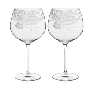 Caskata Lucy Gin & Tonic Glasses—pair of clear, lead-free crystal glasses featuring an etched octopus design wrapping around each bowl.
