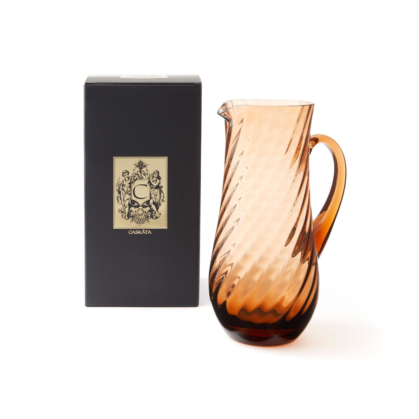 The Quinn Amber Sangria Set by Caskata features a brown glass pitcher with handle and eight matching spiral-textured tumblers, showcasing the classic elegance of Czech glassware.