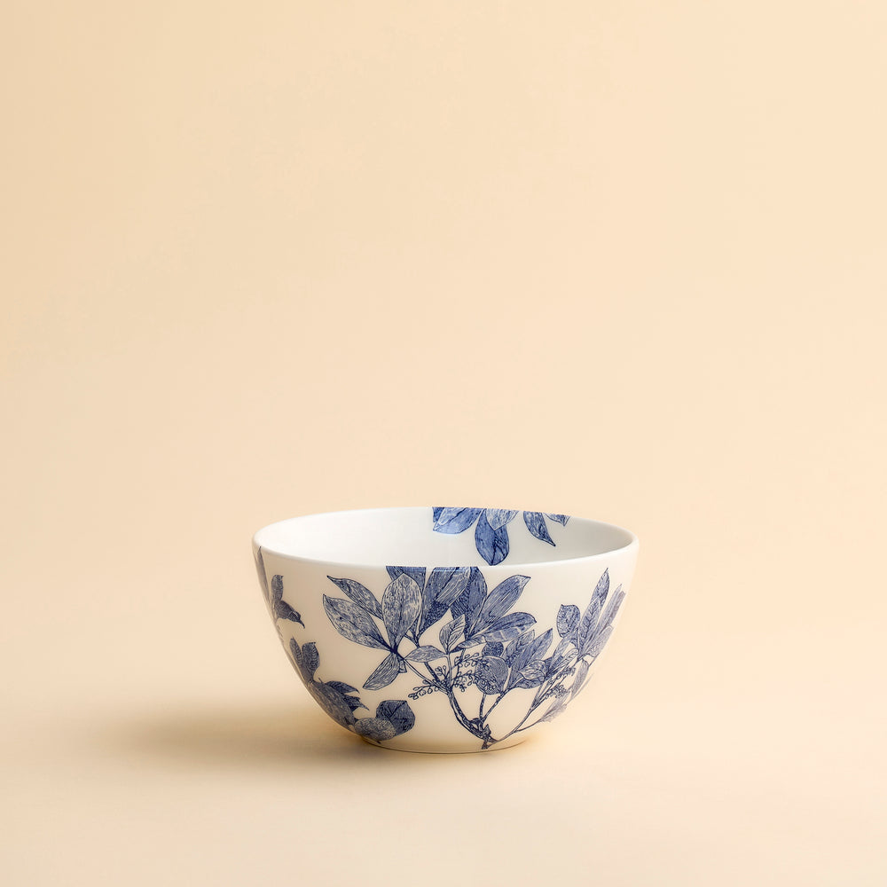 Pretty Arbor blue and white cereal sized bowl showcases floral engravings in a contemporary scale on this porcelain bowl from Caskata