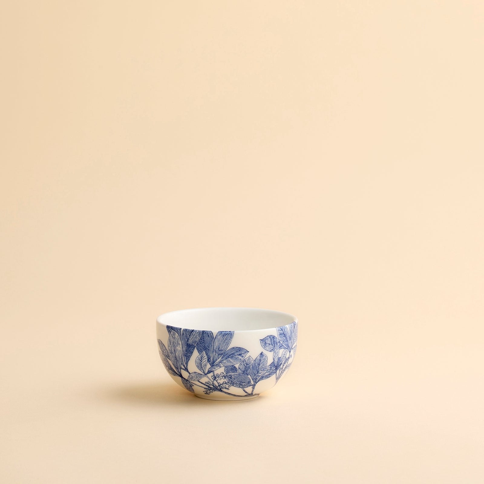Arbor blue snack bowl shows delicate floral engravings on creamy white porcelain in this small bowl from Caskata