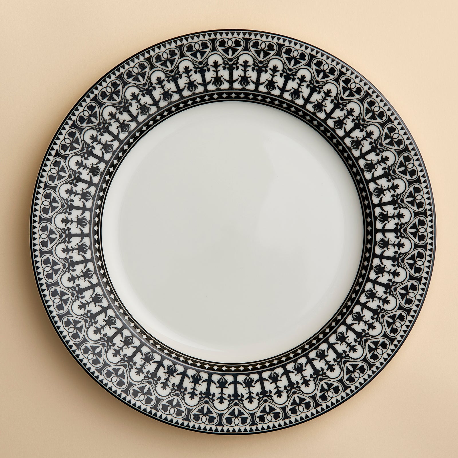 Richly patterned dinnerware in black and white on this rimmed dinner plate evokes the lush decorative details of Morocco in a contemporary motif called Casablanca from Caskata