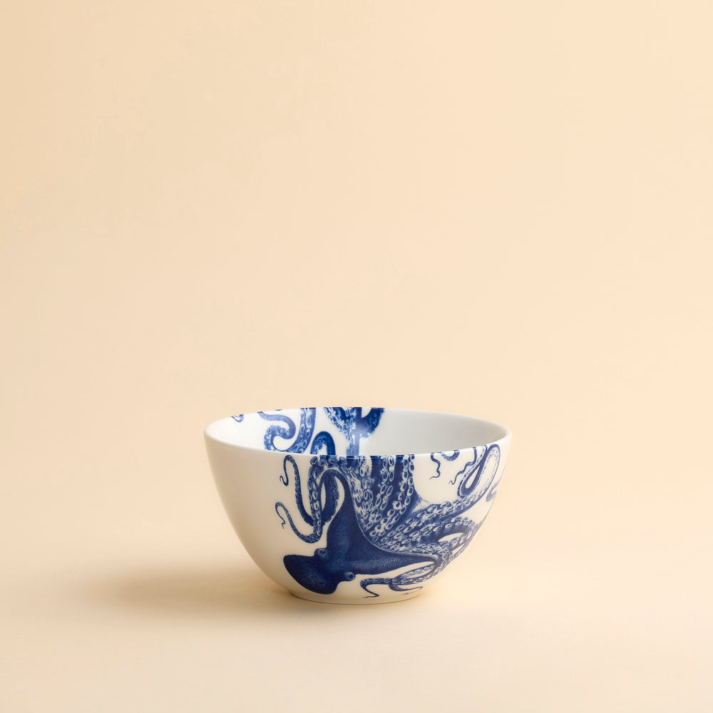 Lucy the Octopus wraps playfully around the sides and over the rims of this pretty blue and white porcelain cereal bowl from Caskata.