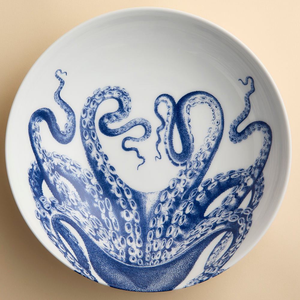 A big, beautiful serving bowl  featuring Lucy the Octopus wrapping around this high-fired porcelain bowl from Caskata, perfect for serving a crowd.