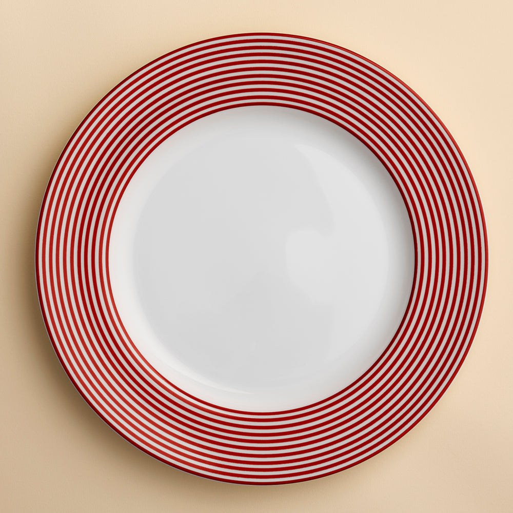 Newport Stripe Crimson Dinner plate shows rings of concentric circles of crimson red around the rim of this porcelain dinner plate from Caskata.