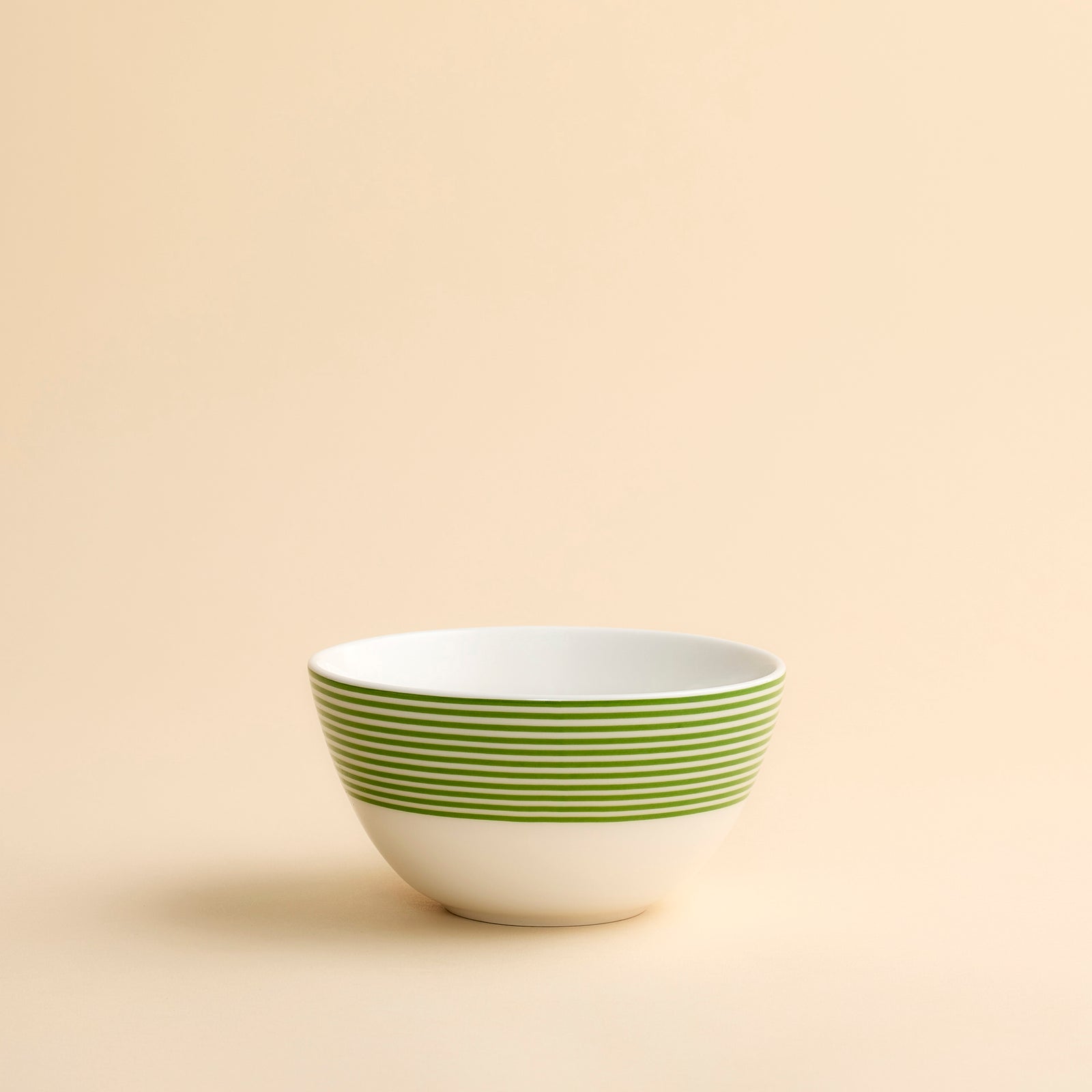 Newport Verde Cereal Bowl in porcelain with bright green concentric lines around the top half of this perfectly sized bowl from Caskata.