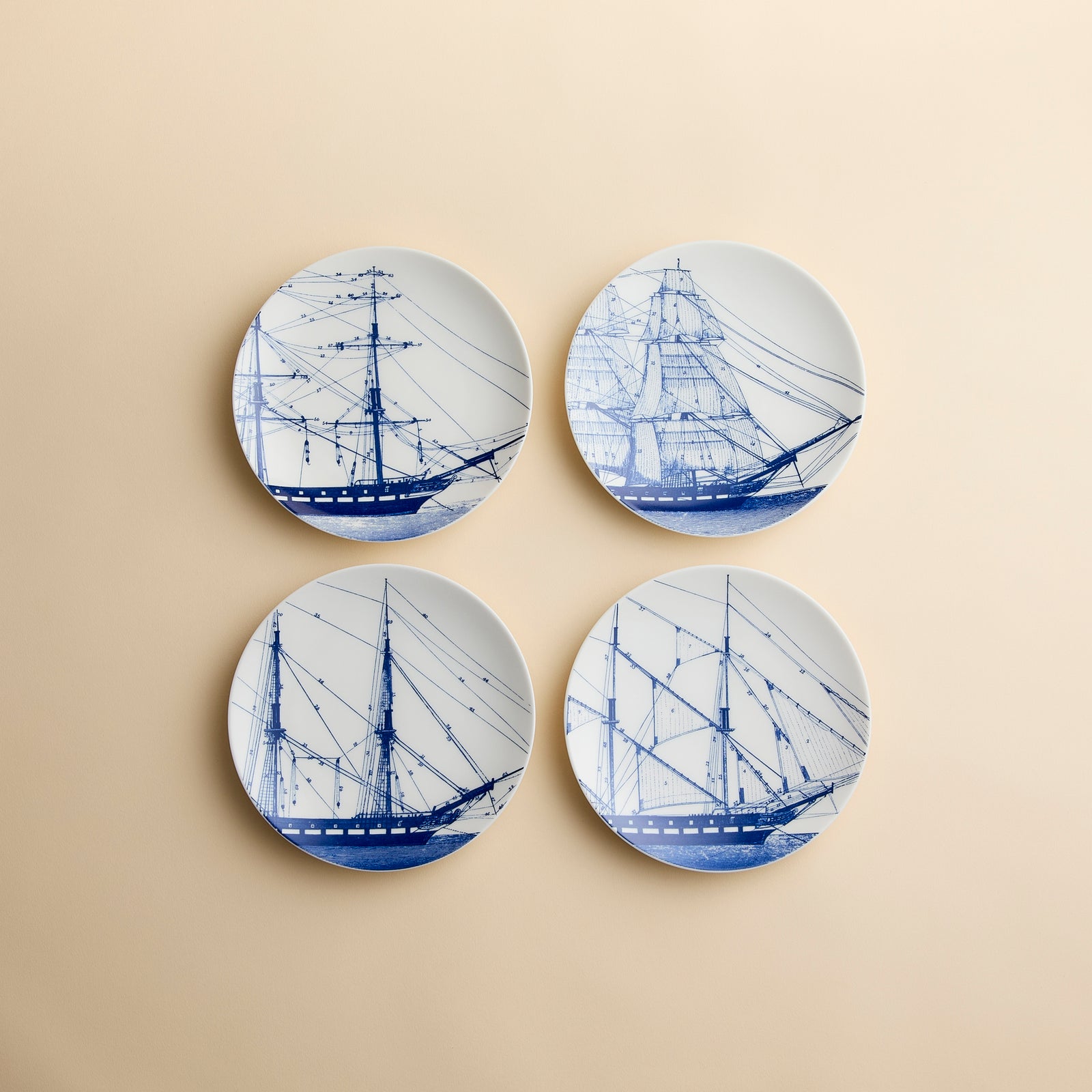 Rigging plates in blue and white porcelain on this small plate set of 4 from Caskata showing intricate rigging on antique sailing ships-  different ships