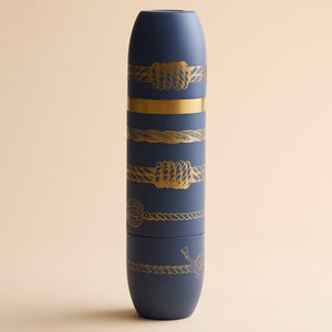 Matte dark blue cylindrical Caskata x High Camp Dark Blue Sailors Knots Wine Flask decorated with gold-toned nautical rope patterns.