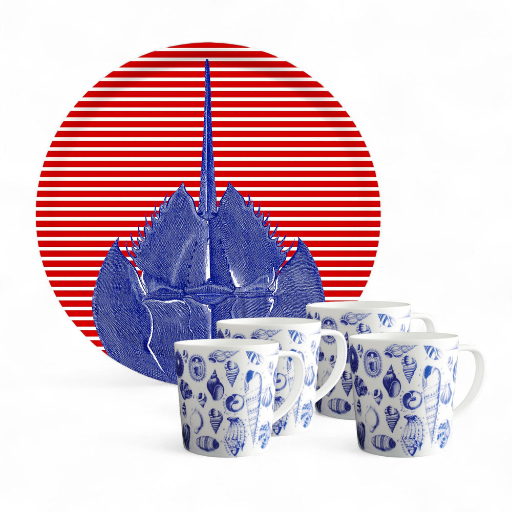 The Caskata Seaside Brunch Bundle includes a Horseshoe Crab Serving Tray with a blue crab illustration and red stripes, paired with four Shells Mugs featuring blue seashell designs—perfect for a coastal-themed brunch.