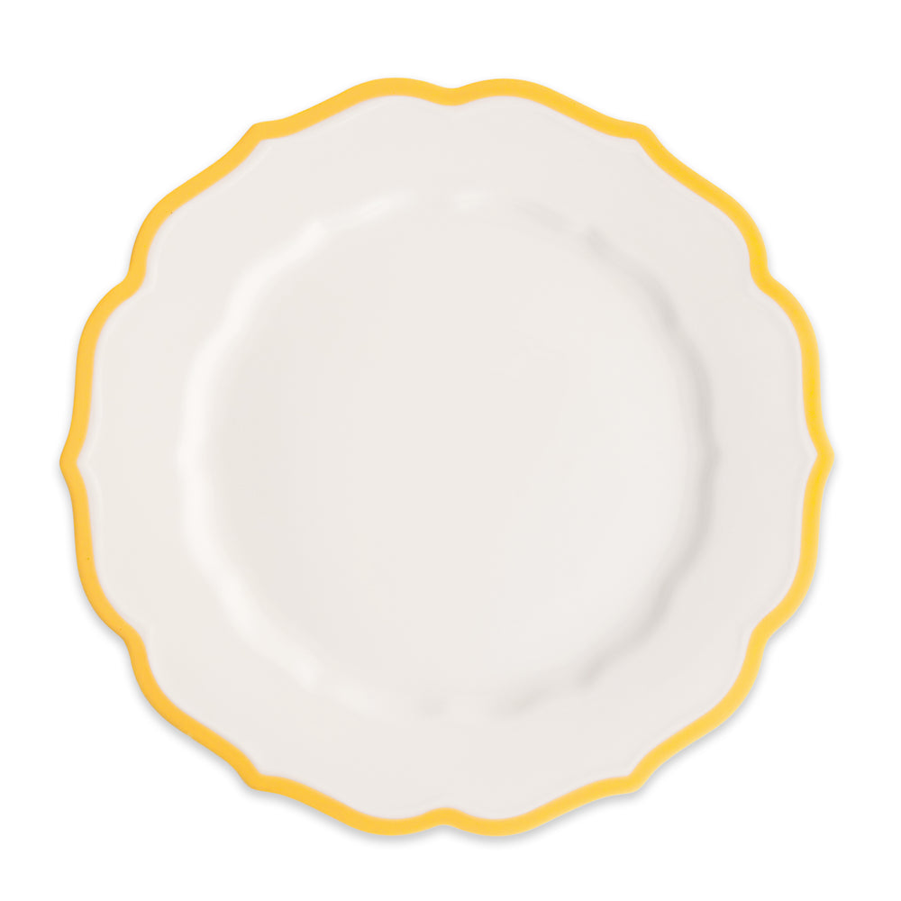 The Stella Scalloped Marigold Dinner Plate by Caskata features a white porcelain design with a decorative scalloped edge and yellow border, shown from above on a plain background.