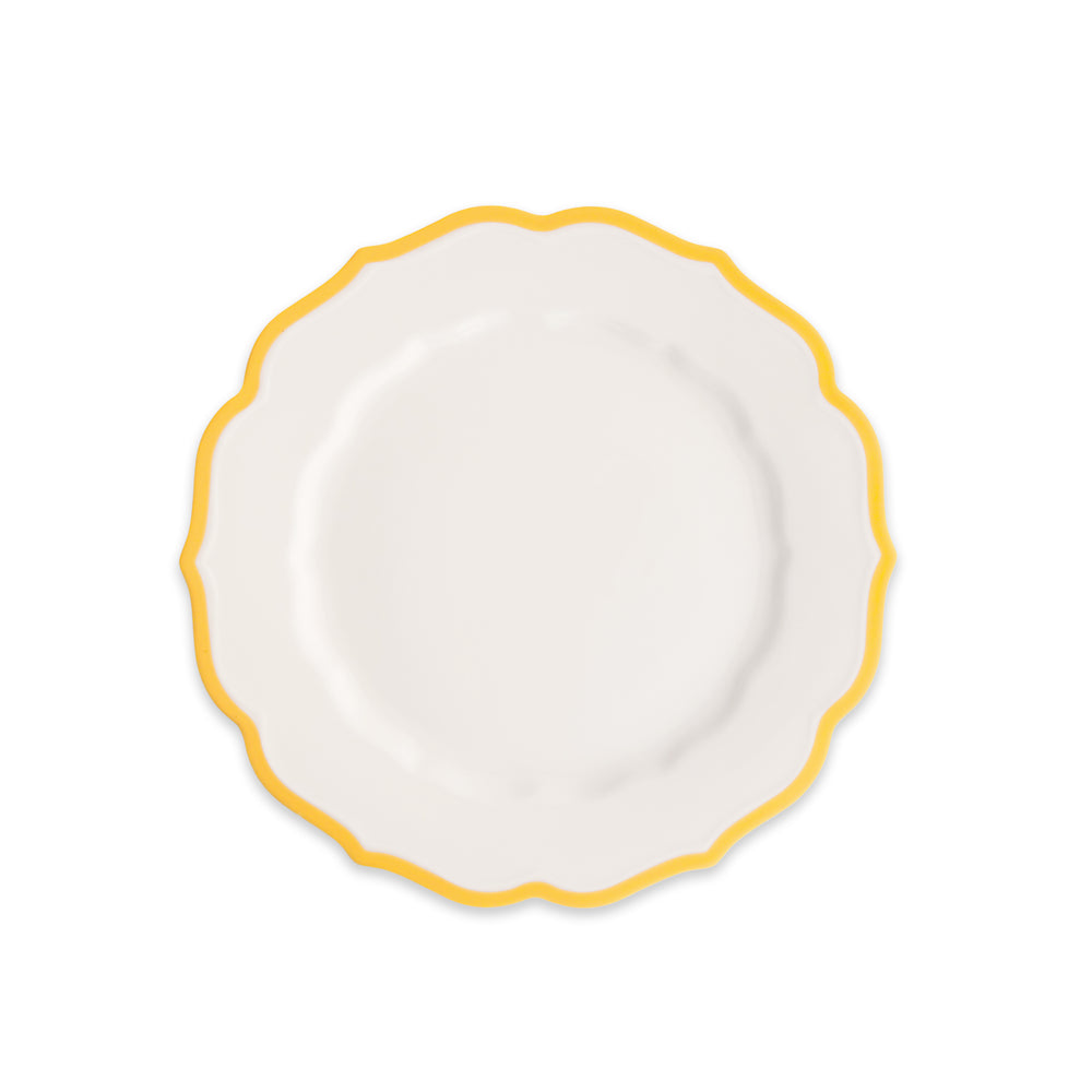The Caskata Stella Scalloped Marigold Salad Plate is an elegant white porcelain plate with a scalloped edge and yellow border, shown on a plain white background.
