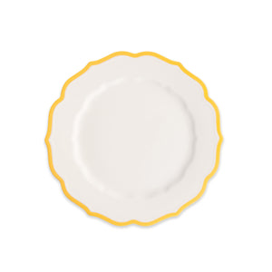 The Caskata Stella Scalloped Marigold Salad Plate is an elegant white porcelain plate with a scalloped edge and yellow border, shown on a plain white background.