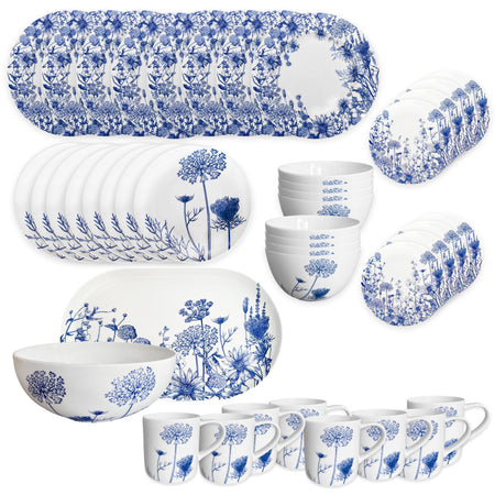 The Caskata Summer Blues Ultimate Set is a 42-piece porcelain dinnerware collection with blue floral patterns, featuring plates, bowls, mugs, and serving platters arranged elegantly.